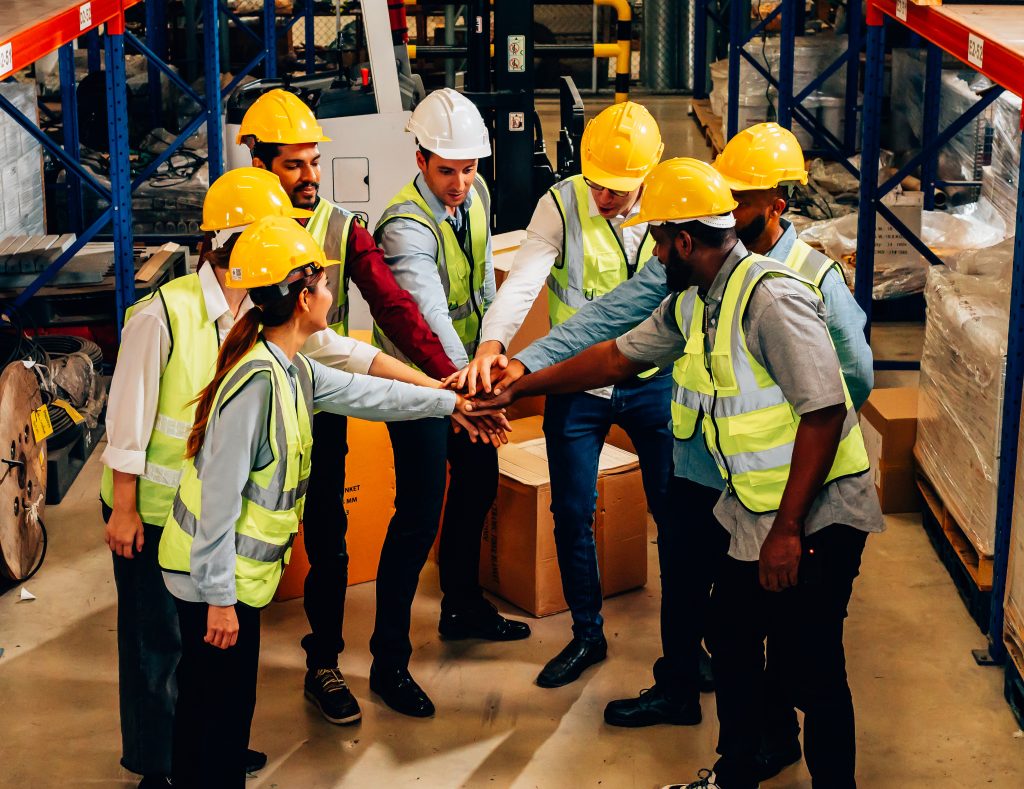 Professional warehouse worker team celebrating success in warehouse factory